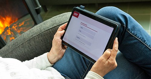Person som sitter med en surfplatta och är inloggad i Min vårdplan via 1177.